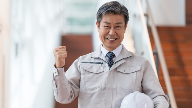 ガッツポーズをする建設業の経営者